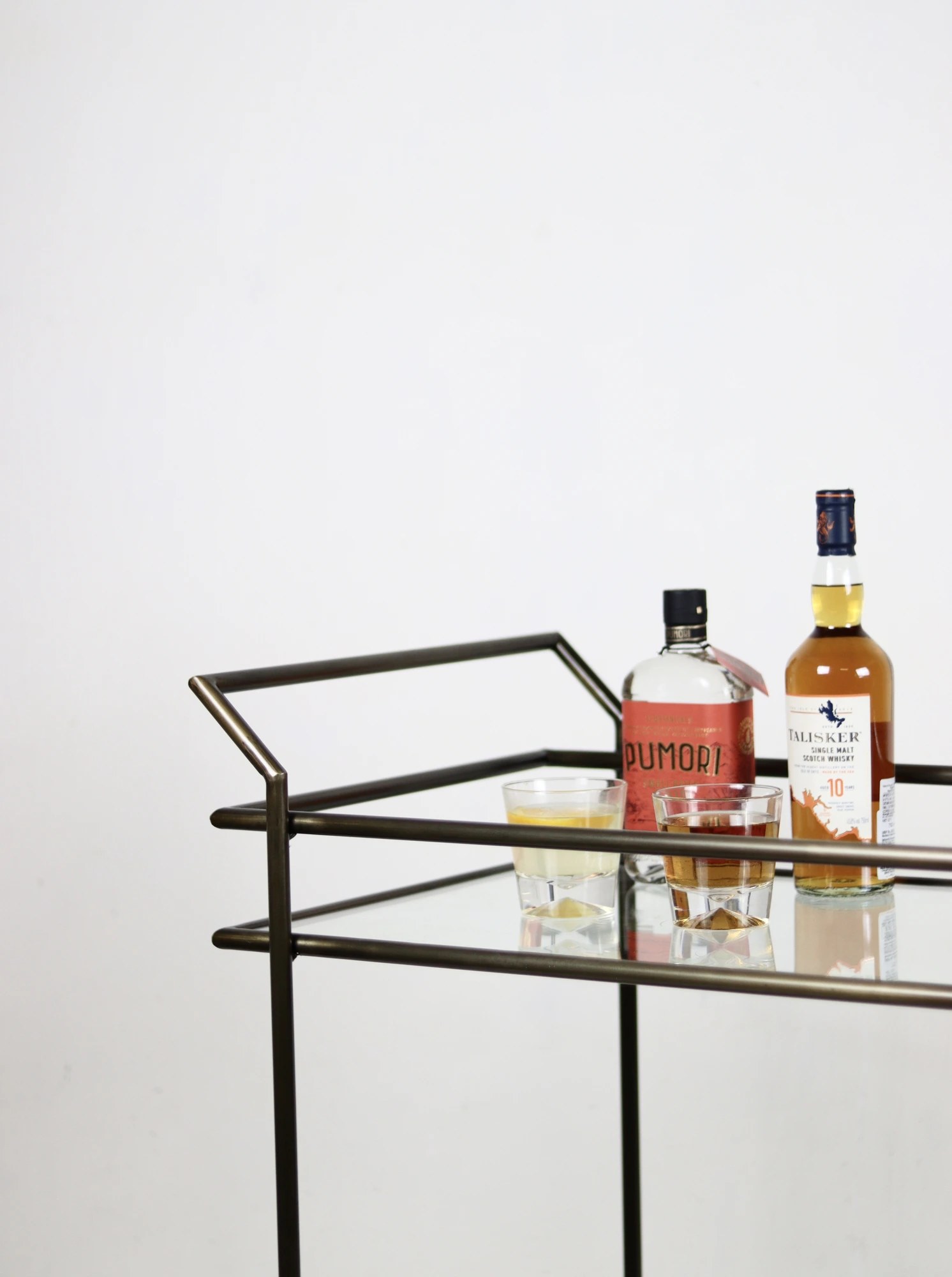 Cle and Co — bar cart with bottles and glassware