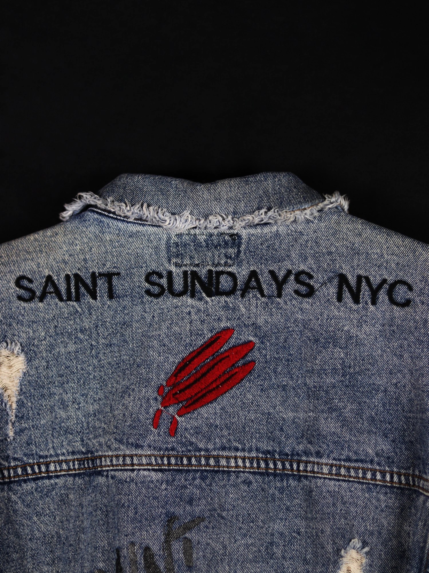 Umca — denim jacket yoke with 'Saint Sundays NYC' embroidery